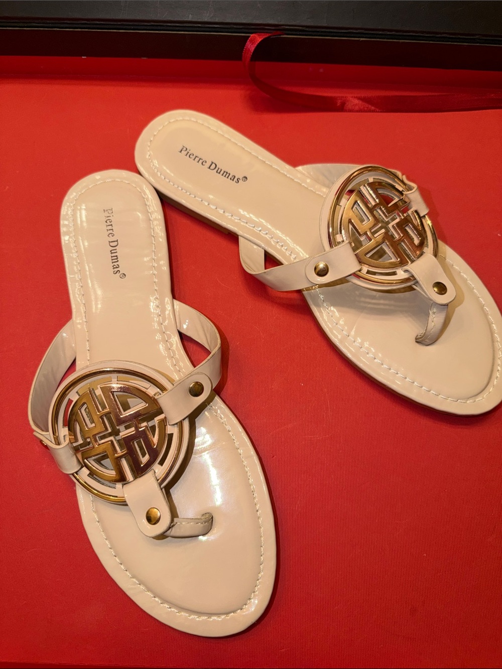 Pierre Dumas Bright Nude Patent T-Strap Sandal with Gold Emblem
